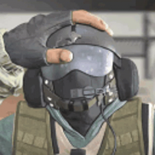 A Man Wearing A Helmet And Headphones Is Being Held By Another Man . GIF