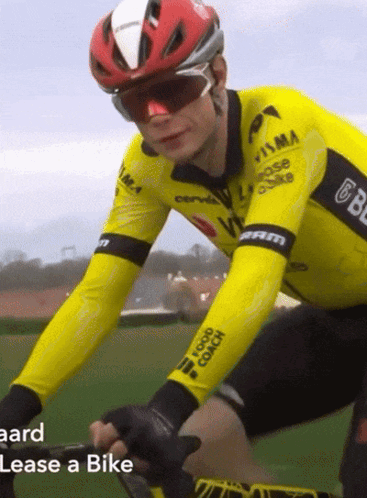 A Man Wearing A Helmet And Sunglasses Is Riding A Bike With The Words Lease A Bike Below Him GIF