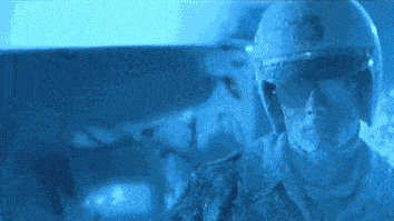 A Man Wearing A Helmet And Sunglasses Looks At Something GIF