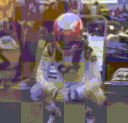 a man wearing a helmet is kneeling down on the ground .