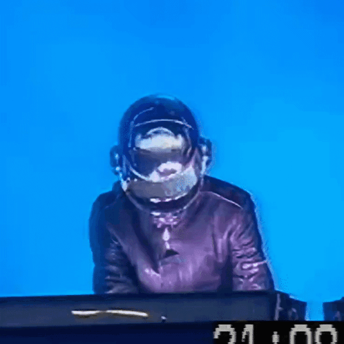 a man wearing a helmet is playing a keyboard with a clock that says 21:00 on it