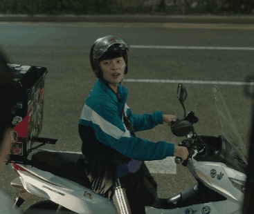A Man Wearing A Helmet Is Riding A Motorcycle With A Box On The Back Of It GIF