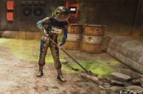 A Man Wearing A Helmet Is Sweeping The Ground In Front Of Barrels With A Warning Sign On Them GIF
