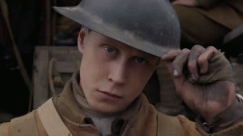 A Man Wearing A Helmet Looks At The Camera With A Serious Look On His Face GIF