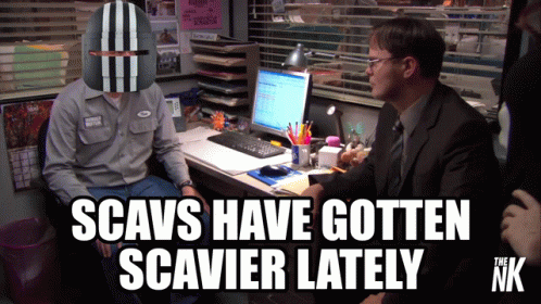 A Man Wearing A Helmet Sits At A Desk With The Words Scavs Have Gotten Scavier Lately GIF