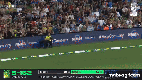 A Man Wearing A Helmet Stands In Front Of A Screen That Says Cricket On It GIF