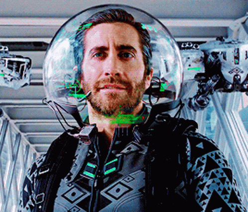 A Man Wearing A Helmet With A Green Light Coming Out Of It GIF