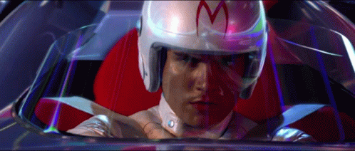 A Man Wearing A Helmet With The Letter M On It Is Sitting In A Car GIF