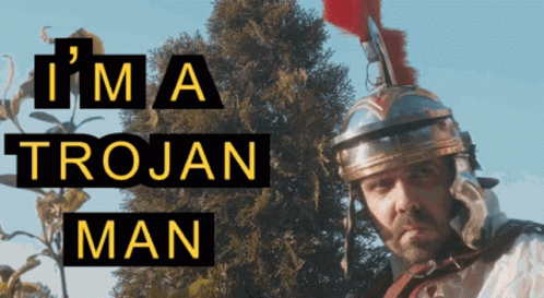 A Man Wearing A Helmet With The Words I 'M A Trojan Man Behind Him GIF