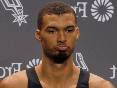 A Man Wearing A Hilton For The Stay Branded Shirt GIF