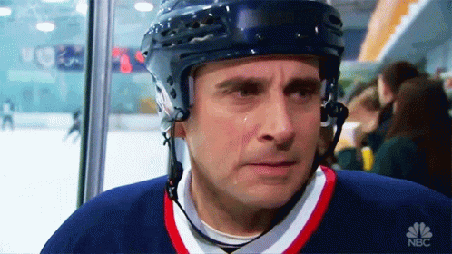 A Man Wearing A Hockey Helmet Is Crying While Wearing A Nbc Shirt GIF