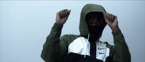 A Man Wearing A Hooded Jacket With A Nike Logo On The Front GIF