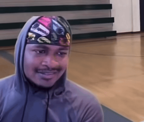 A Man Wearing A Hooded Sweatshirt And A Headband With A Picture Of A Car On It Is Smiling GIF