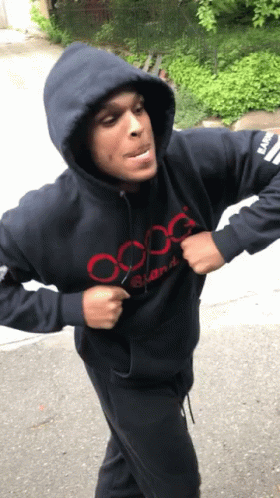 A Man Wearing A Hooded Sweatshirt That Says Oxg GIF