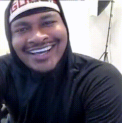 A Man Wearing A Hoodie And A Hat With The Word Elite On It Smiles For The Camera GIF