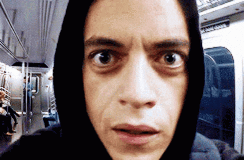 A Man Wearing A Hoodie Is Taking A Selfie On A Train GIF