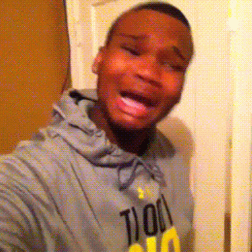 A Man Wearing A Hoodie That Says 100 On It Is Taking A Selfie GIF