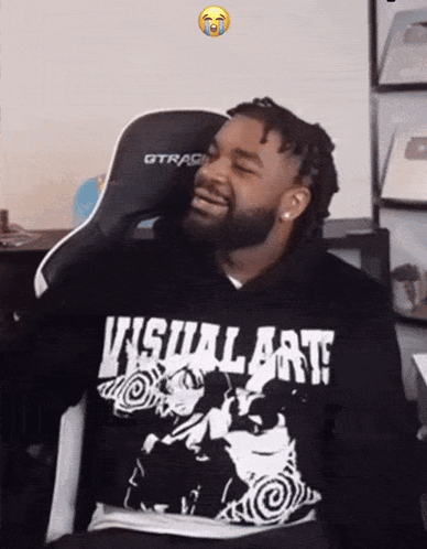 A Man Wearing A Hoodie That Says Visual Art Is Smiling GIF