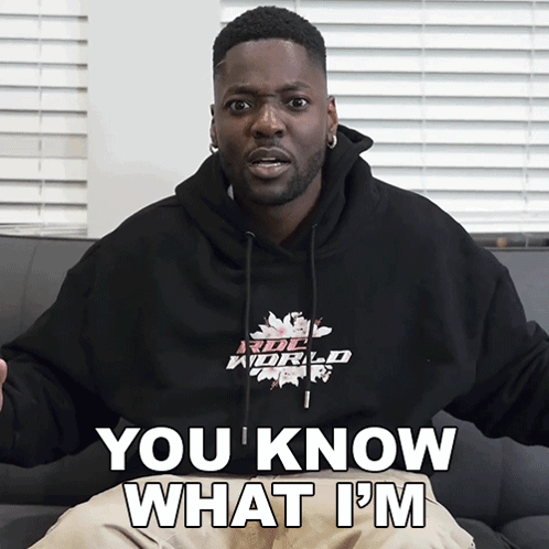 A Man Wearing A Hoodie That Says " You Know What I 'M " Is Sitting On A Couch GIF