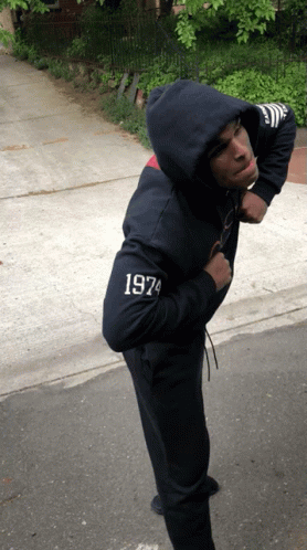 A Man Wearing A Hoodie With 1974 On The Sleeve GIF