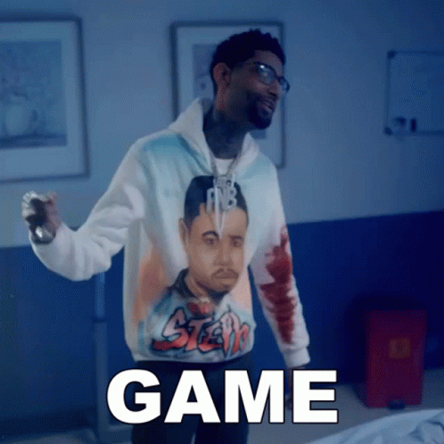 A Man Wearing A Hoodie With A Picture Of A Man And The Word Game GIF