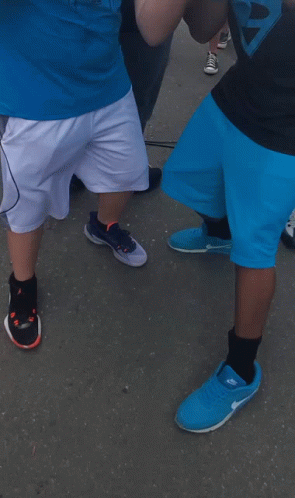 A Man Wearing A Horn Jersey Stands Next To Another Man GIF