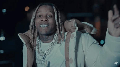 A Man Wearing A Jacket And A Necklace With A Pendant That Says ' Grungy ' On It GIF