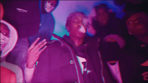 A Man Wearing A Jacket That Says Essentials On It GIF