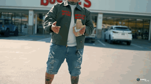 A Man Wearing A Jacket That Says " That 'S A Lot Of Money " On It GIF