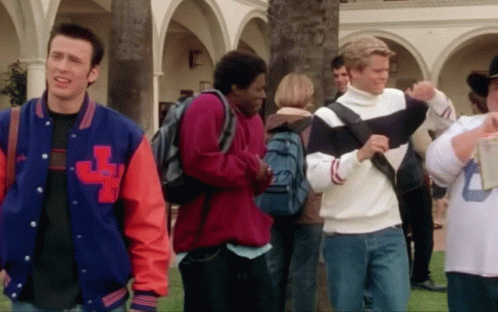 A Man Wearing A Jacket With The Letter L On The Front GIF