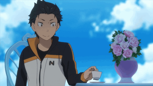 A Man Wearing A Jacket With The Letter N On It Sits At A Table GIF
