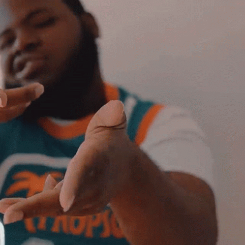 A Man Wearing A Jersey That Says Miami GIF