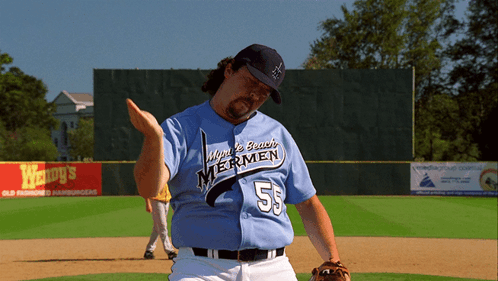 A Man Wearing A Jersey That Says Windy Beach Mermen On It GIF