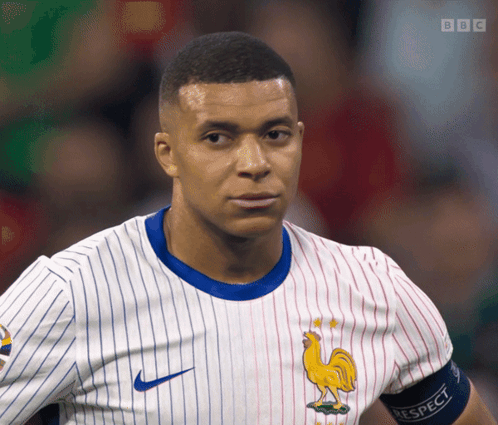 A Man Wearing A Jersey With A Rooster On It And A Bbc Logo GIF