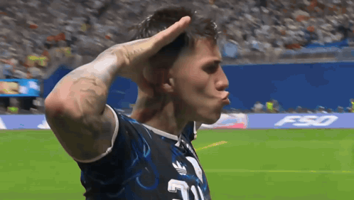 A Man Wearing A Jersey With The Number 21 On It Salutes On A Soccer Field GIF