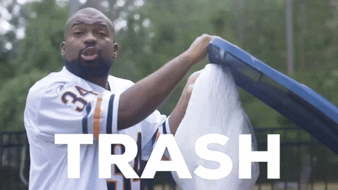 A Man Wearing A Jersey With The Number 34 On It Is Holding A Trash Can GIF