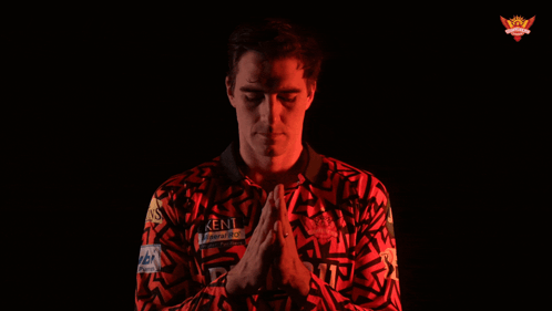 A Man Wearing A Kent Shirt With His Hands Folded GIF