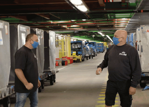 A Man Wearing A Klm Shirt Stands In A Warehouse GIF