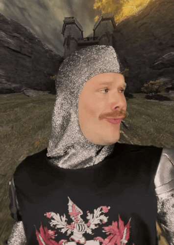 A Man Wearing A Knight 'S Helmet And Armor With A Crest On His Chest GIF