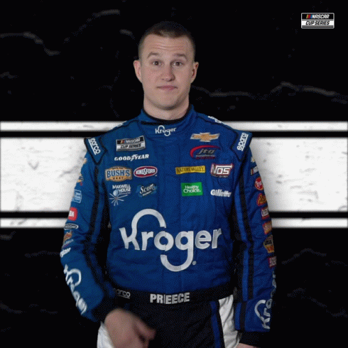 A Man Wearing A Kroger Racing Suit Looks At The Camera GIF