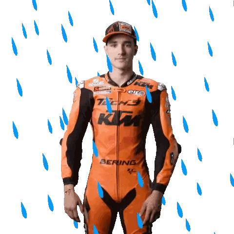 a man wearing a ktm motorcycle suit is standing in the rain