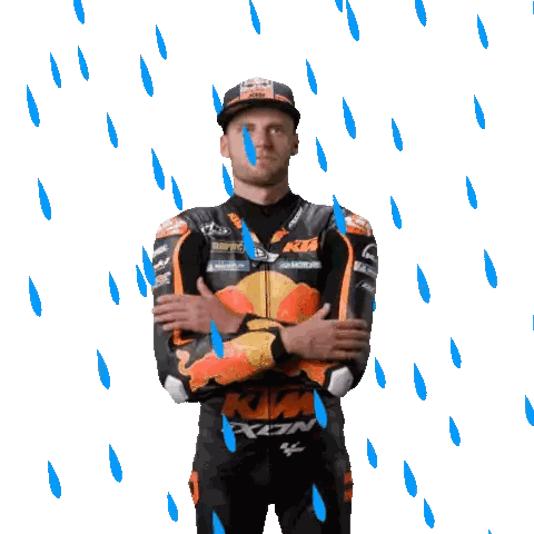 a man wearing a ktm racing suit stands in the rain