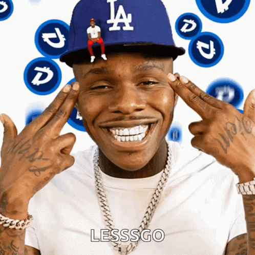 A Man Wearing A La Dodgers Hat Is Smiling With His Hands On His Forehead GIF