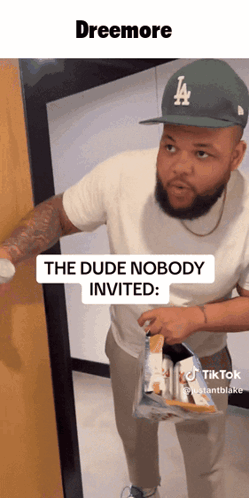 A Man Wearing A La Hat Is Holding A Bag Of Chips And Says The Dude Nobody Invited GIF