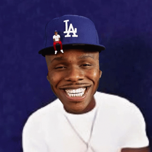 A Man Wearing A La Hat With A Man Sitting On Top GIF