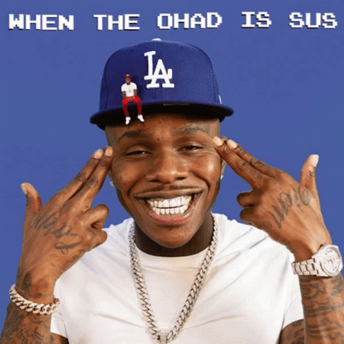 A Man Wearing A La Hat With A Tiny Man Sitting On It GIF