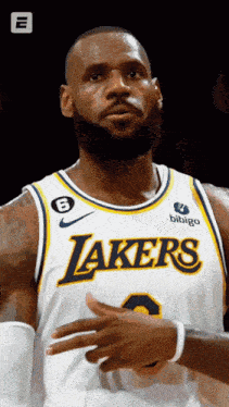 a man wearing a lakers jersey with the number 8 on it