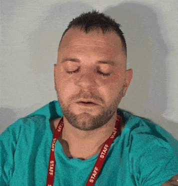 A Man Wearing A Lanyard That Says Staff GIF