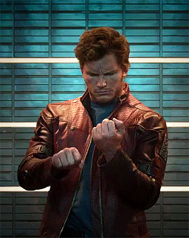 A Man Wearing A Leather Jacket Is Making A Fist GIF