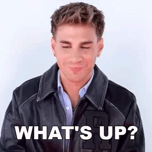 A Man Wearing A Leather Jacket Is Making A Funny Face And Says What 'S Up ? GIF